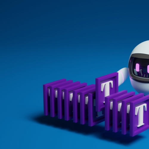A 3D rendering of a blue robot arm holding a block with the letter "T" written on it. The background is white.
